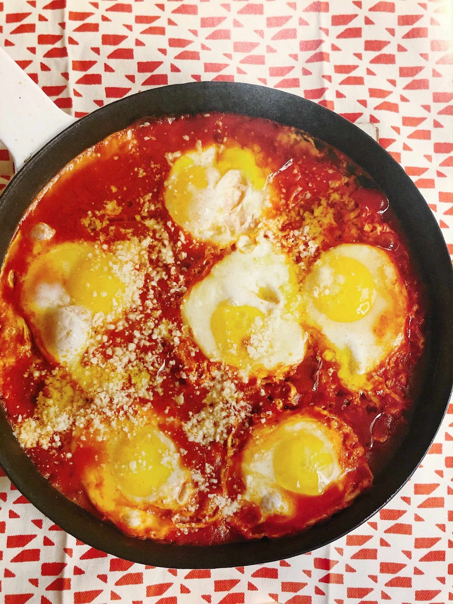Sunny-side up eggs in tomato sauce in a skillet