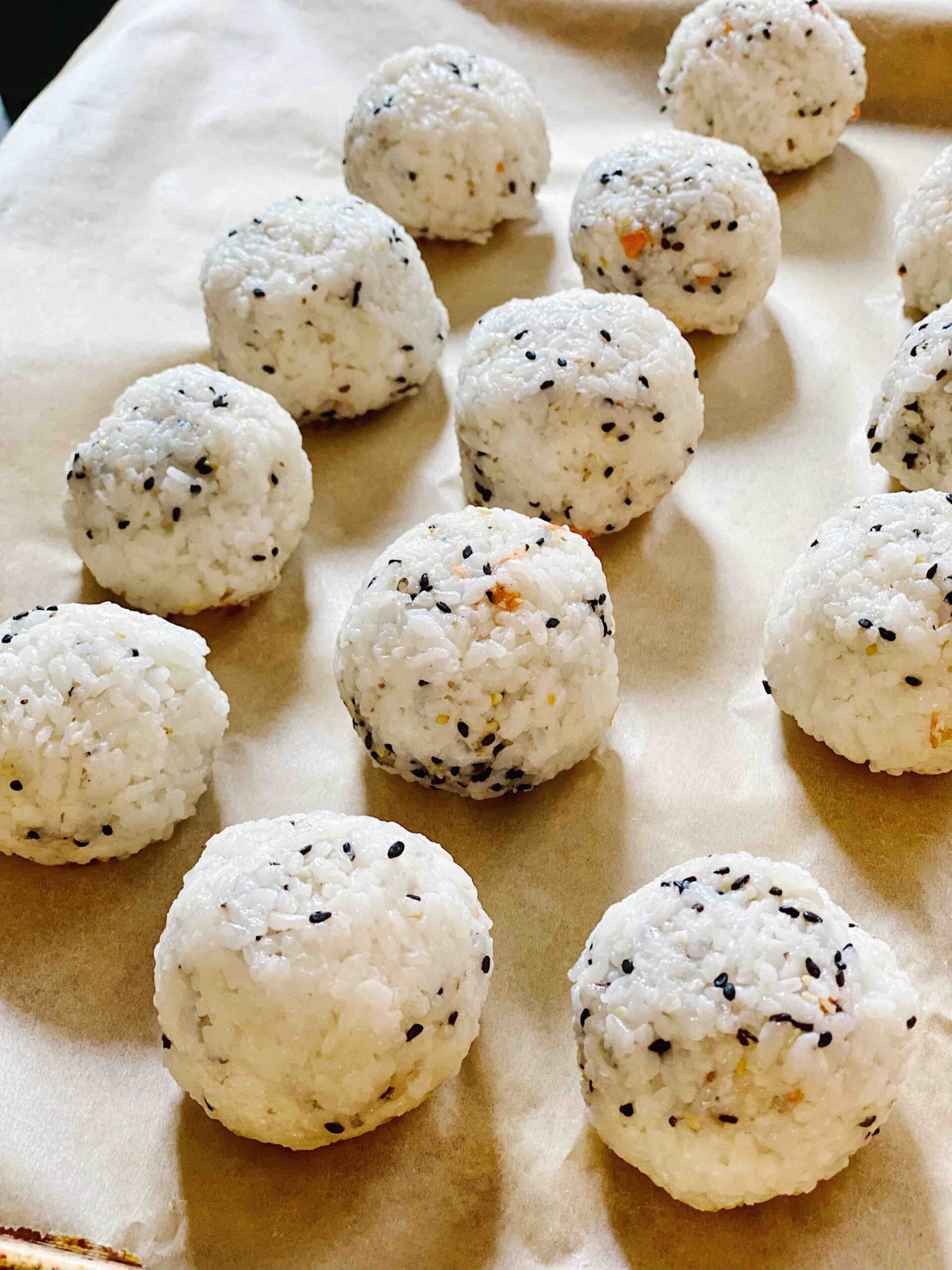 Sticky Rice Balls on a Parchment-lined baking sheet